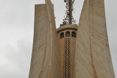 It is fashioned in the shape of three standing palm leaves, which shelter the "Eternal Flame" under it.