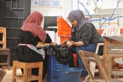 Women from the residences and family living in the building preparing food for the noon meal.