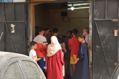Waiting at the door to buy bread daily.
