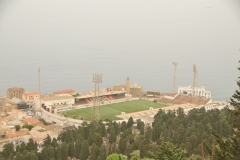 A view from the Basilica Our Lady of Africa one finds a lighted soccer field below near the Mediterranean.