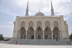 The side entrance with its lattice work on the arches and entrance doors, twin minarets stand out with the blue sky of Constantine. 