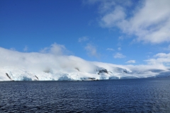 Antarctica is Earth's southernmost continent. It contains the geographic South Pole and is situated in the Antarctic region of the Southern Hemisphere, almost entirely south of the Antarctic Circle, and is surrounded by the Southern Ocean. At 5,400,000 square miles, it is the fifth-largest continent. For comparison, Antarctica is nearly twice the size of Australia. About 98% of Antarctica is covered by ice that averages 6,200 feet in thickness, which extends to all but the northernmost reaches of the Antarctic Peninsula.