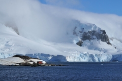 The abandoned building is like an ant in retrospect to the landscape and massive ice formations. The hill in the foreground next to the shack is filled with penguin colonies that we will soon visit.