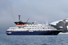 Our ship is the Corinthian. We are seeing it for the first time, away from the ship, flying across the water in zodiacs each with 8 persons and a crew member maneuvering it. We walked down a flight of stairs after changing into special boots assigned to each passenger, we climb into the zodiac from the rear of the ship and depart. We have 90 passengers aboard the ship plus crew.