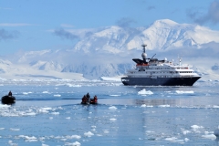 Zodiacs returning to ship and another returning to shore to pick up returning passengers.
