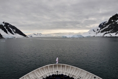 Sun suddenly hiding behind clouds as we depart from a bay..