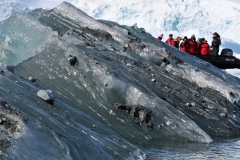 You can see visible the dirt trapped inside the glacier hundreds of thousands of years ago as it is melting into the ocean.