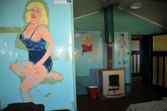 Obviously there were no women at the base early on so paintings of young ladies were painted on the walls where men slept.