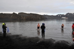 Carefully walking back out stepping on sharp volcanic rock bottom.