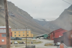 The town is built right into the surrounding hills.Everyone that lives there is from the outside and women are not allowed to give birth there. Due to the remote location, a few weeks before their due date women are obliged to go to mainland Norway to have their babies.