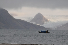 Zodiac out on the water. Notice the glaciers and mountain peak across from the Smerenburg.