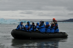 Close up of a group with the expedition guides manning the zodiac.