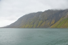 Rugged mountains fall straight into the ocean