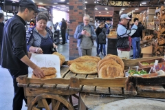 As fast as the hot bread comes from the open round oven it is sold.