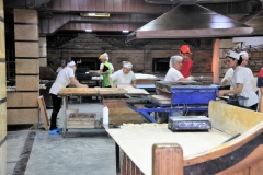 Employees working hard in the kitchen to create these great treats to enjoy.