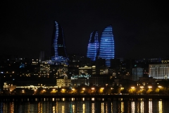 The Flame Towers illuminated at night with millions of LED lights on the buildings.