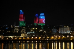 The National flag of Azerbaijan lighted in movement upon the 3 towers.