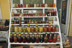 Many home grown fruits and vegetables prepared and placed in jars and cans  for sale retail. for sale.  They look good too.