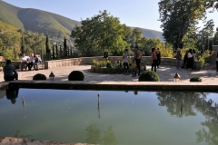 The summer residence is renowned for the lavish decoration of its exterior.   Outside garden area of the palace.  Remaining surfaces on all façades are decorated with floral tile panels and tile mosaics .  Muqarnas hoods crowning the four iwans,  a rectangular hall or space, usually vaulted, walled on three sides, with one end entirely open. are highlighted with gold on the lower level and covered with mirror fragments on the first floor.  .