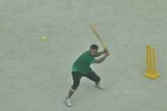 Cricket player in the morning on a dirt lot