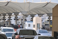 Saudi Arabia frontier crossing leaving the country. Looking into Saudi Arabia. There is a reason for all those fans at the crossing. Can you imagine working outside in the hot summer at the border crossing with a 125 plus degree temperature?