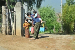 Mother attending to hee children. Notice the local dress for this young mother