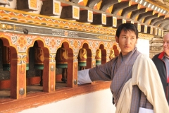 Tashi is explaining the prayer wheels - you walk along them and turn each of them and your prayers hopefully will be answered