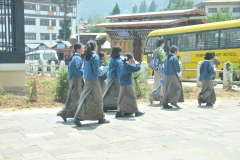 Young girls coming from school and going home in the afternon. Note their uniforms.