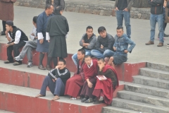 Young teenagers and monks enjoying the DJ music from the car show