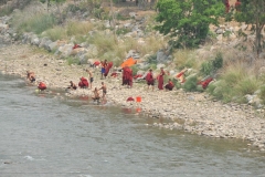 Young Monks in residence bathing in the nearby river