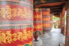 Elderly pilgrims constantly spinning the many prayer wheels at the Monastery