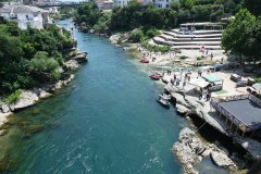 Looking down the river from the bridge. During the conflict that tore apart the former Yugoslavia in the 1990s, the beautiful Old Bridge in Mostar, Bosnia and Herzegovina, was completely destroyed. On 9 November 1993, after relentless shelling, the elegant structure disintegrated and fell into the Neretva River.