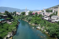 Looking up the river from the bridge. The bridge and Mostar's historic city center were restored in 2004. Today it is a UNEXCO HERITAGE Site and represents a symbol of reconciliation and continued peace for the region. The  Old Bridge at Mostar was not exclusively a bridge for Protestants and Muslims; it was a symbol of coexistence and a link between the Muslim and Christian communities of the city. 