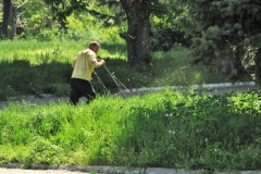 Here you see a man mowing grass with a small power lawnmower in a public park. Unfortunately the economy has been declining for a number of years. There are few funds for anything today. Even fewer jobs. The average income I was told is around the equivalent of $300 US a month.