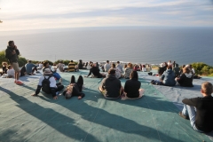 People sitting on the green plastic covering waiting for the sunset on Signal Hill.  Also during the day they have hang gliders take off from there and land on the grassy areas below near the beach. What a kick that must be.
