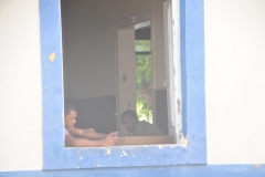 Soldiers in in the window of the Quartel, building.