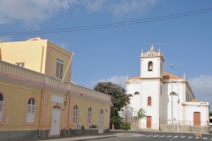 The bell tower is at the rear of the The Pro-Cathedral of Our Lady of Grace church across the street from the Amilcar Cabral Museum