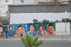 Walking the streets we see faces of locals painted on a wall.