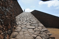 Rock ramp going from the dirt floor below to the top of the fortress.