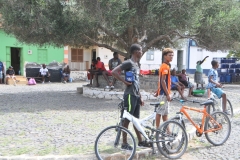 Local kids with their bikes taking in all the tourists that over took their village plaza for an hour or so.