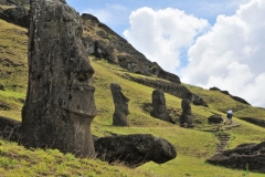 Rano Raraku was chosen as a factory not for its location, but for the rock it consists of. The material is called tuff (or sometimes tufa, which is simply volcanic ash. This particular volcano spewed out huge amounts of ash during its eruption, and when this ash landed on the ground, it melted together, forming the tuff material. Prevailing southward winds during the eruption was what gave the volcano its peculiar shape of a long slope.