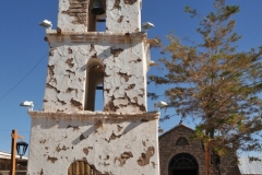 Toconao is a village 24 miles south of San Pedro de Atacama in the San Pedro de Atacama province of Chile's northern Antofagasta Region. It lies at an elevation of 8,153 feet above sea level, close to the northeast margin of the Salar de Atacama.  The most notable building in Toconao is its church. The bell tower is separated from the main church structure and dates from 1750.