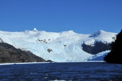 Thousands of feet high the glaciers rise from the fjord.