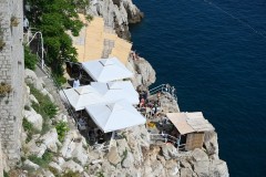 Below the wall on the seaside is a popular small venue for drinks, food and sunbathing. The bars 2 of them are known as the Buza Bars. 