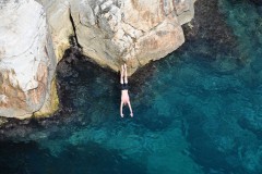 A diver caught in flight into the  clear water of the Adriatic.