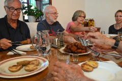 The dinner was excellent. Much of the meal was from their garden. The wife is at the head of the table. They have two young daughters. 