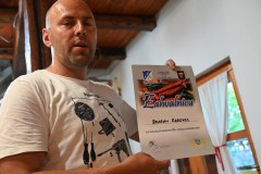 Dragan is showing us an award he recently received in a competition for winning the best tasting sausages.  They were really good., 