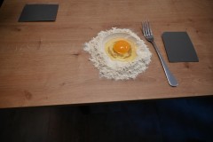 It all starts with flour and a large egg in the center of the flour.