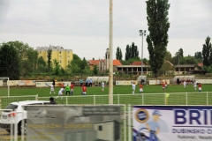 Young boys playing football, soccer, in the early morning.