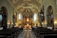 Inside the Church of the Raising of the  Holy Cross. The basic exterior gives way to an ornate interior which is well worth a visit. There is also a large painting of St. Francis on one wall and the Virgin Mary on the opposite wall.